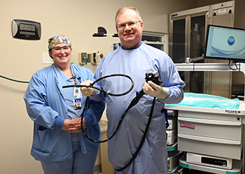 Ashe Memorial Hospital general surgeon Dr. Charles Jones, pictured with operating room manager Michelle Carpenter, began using CAD EYE for colonoscopies in early November.Photo of female nurse with male surgeon holding a CAD Eye.